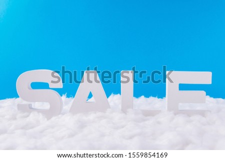 Photo of white letters of word sale standing under blue sky background festive christmas season tradition x-mas commerce concept