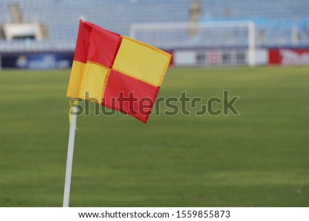 red and yellow soccer corner flag at stadium