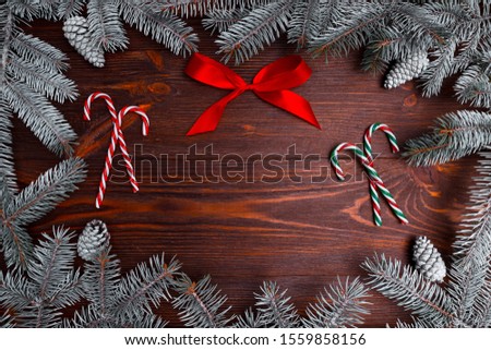 Christmas border with xmas tree and gifts on brown background. Winter holiday. Happy New Year. Space for text. View from above, flat lay. Xmas. Template, mockup. Greeting card.