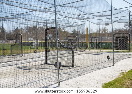 Chain link batting cages in a public baseball park Royalty-Free Stock Photo #155986529