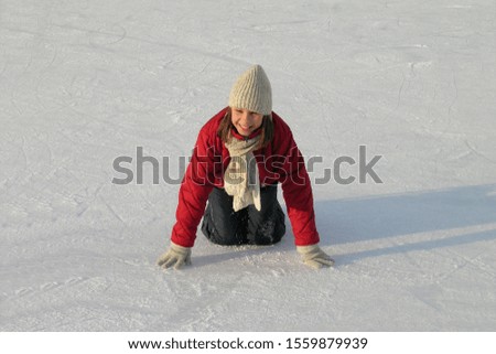 young girl learn figure skating on open ice