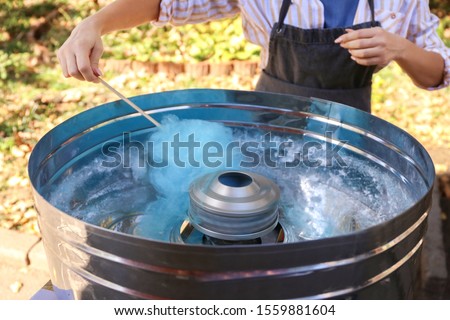 Making of sweet cotton candy outdoors, closeup