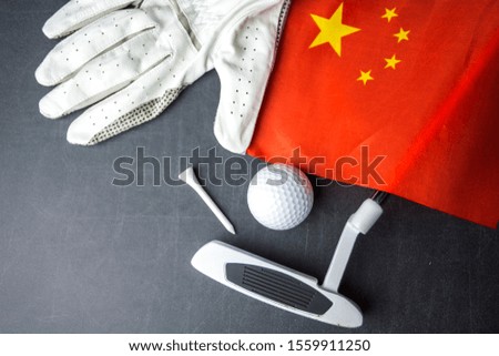 Golf ball with flag of China on wood table
