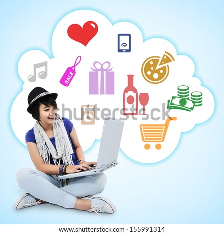 Beautiful young woman is using a laptop, isolated on blue background