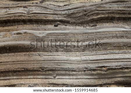 Pyroclastic deposit rock - Due to ancient volcanic activity, thick
layers of sediment are formed along the coast of Jeju Island, Korea Royalty-Free Stock Photo #1559914685