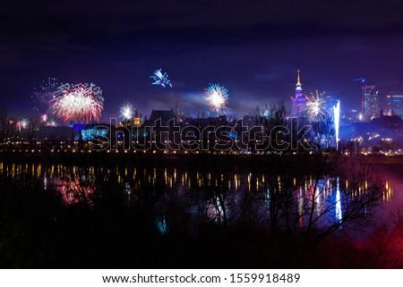 New Year fireworks display in Warsaw, Poland by night, view with Vistula river and city center
