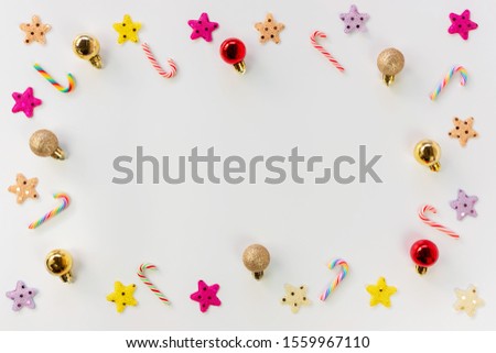 Christmas background concept. Top view of Christmas decoration, colorful star, colorful balls and candy cane on white background with copy space for text.