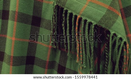 close up of tasseled tartan fabric texture 
