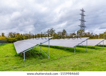 Modern power solar panels and high voltage post in a Dutch landscape