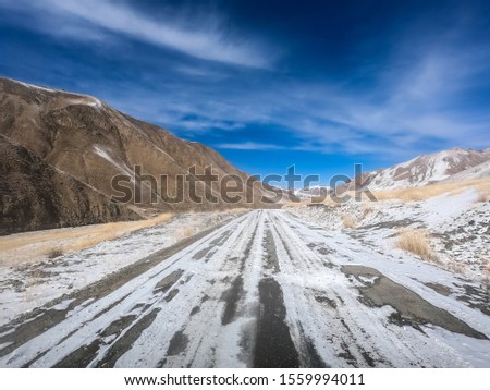gravel road on snow mountain