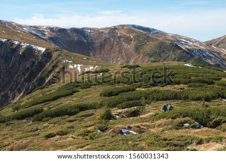 autumn mountains in the Ukrainian Carpathians and travelers stand with their backs