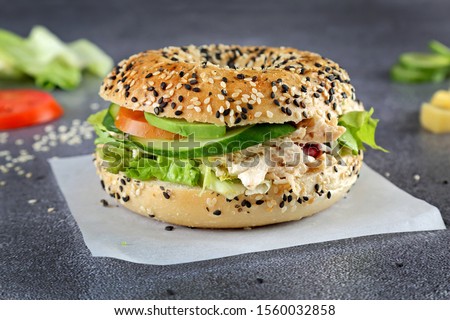 Bagels with tuna , tomato and Lettuce on wooden board and table background. Healthy breakfast food - Image