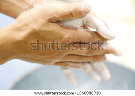 Hands with white chalk powder preparing for sports