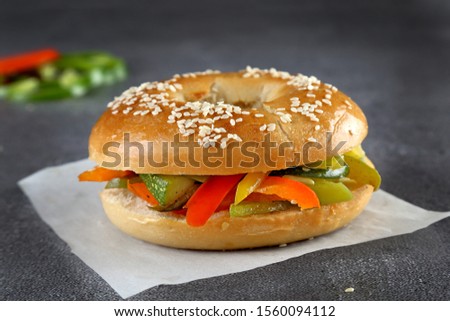 Bagels with mix vegetables and pickles on wooden board and table background. Healthy breakfast food - Image