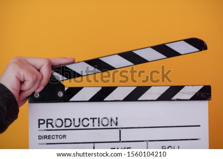 video production movie clapper cinema action and cut concept isolated on yellow background