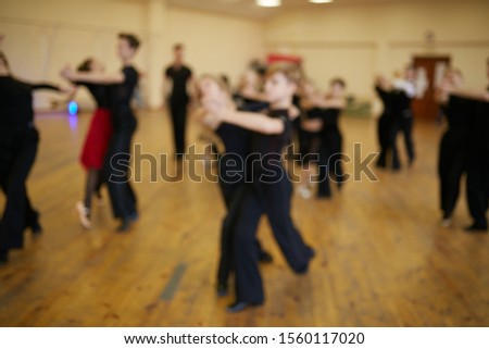 Dancing people blurred photo. Dancing on the wooden floor. The dancers.