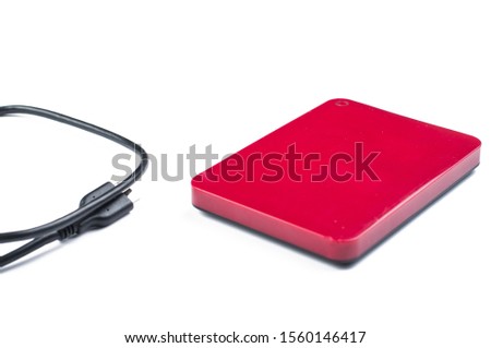 Red external hard with cable isolated on white background.Copy space