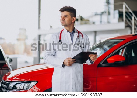 Car doctor with stethoscope in a car showroom
