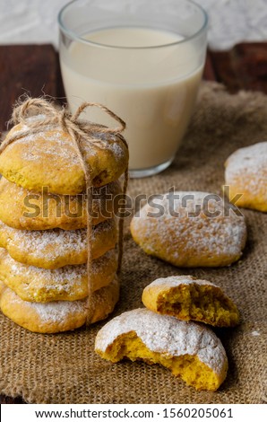 Pumpkin vegan cookies with oat milk on wooden background