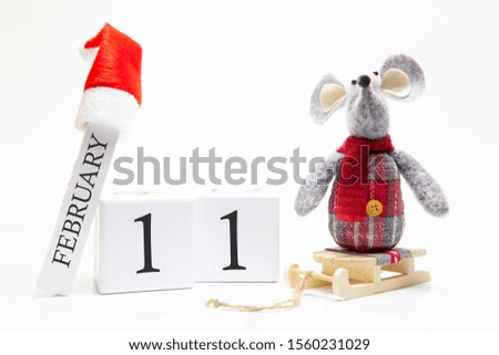Wooden calendar with number February 11. Happy New Year! Symbol of New Year 2020 - white or metal (silver) rat. Christmas decorated.