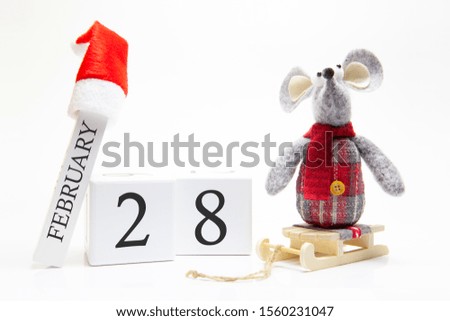 Wooden calendar with number February 28. Happy New Year! Symbol of New Year 2020 - white or metal (silver) rat. Christmas decorated.