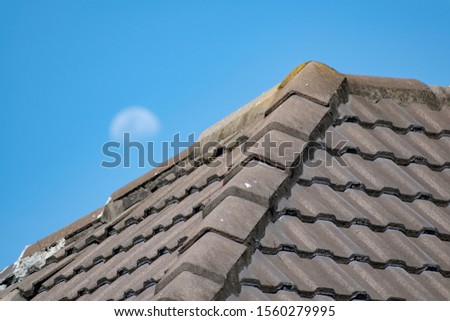 Close-up view of dark gray concrete tile hip roof