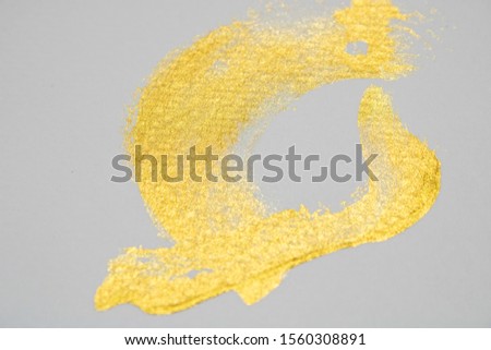 The golden watercolor picture that reflects on the gray background.