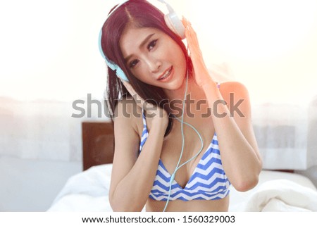 A beautiful girl plan to travel in holiday while sitting on bed, woman wear bikini or underwear posing relaxing in vacation day concept 