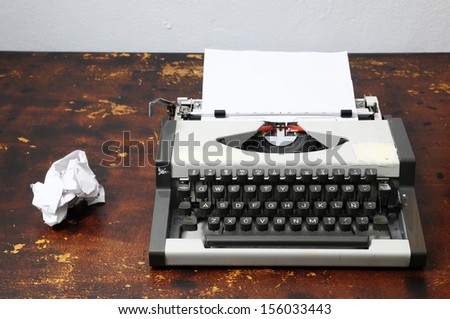 Old Vintage Travel Typewriter on a Brown Wooden Table