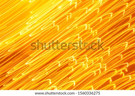 Futuristic blurred lights holiday monochrome background in yellow. Horizontal, soft focus
