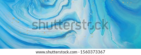 art photography of abstract marbleized effect background. blue, mint and gold creative colors. Beautiful paint