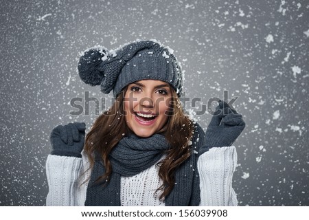 Young ecstatic woman enjoying first snow