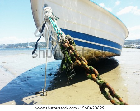 Boat anchored on ocean sand