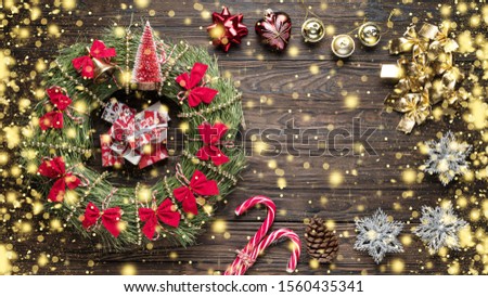 Christmas background with golden snow. Christmas wreath with New Year decorations on a wooden background. Copy space for text