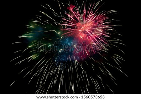 Red Green Blue Sparkling Fireworks Background on Night Scene. Abstract color fireworks background and smoke on sky