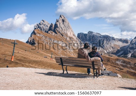 Couple in Love Sitting in the Dolomites near Mount Seceda