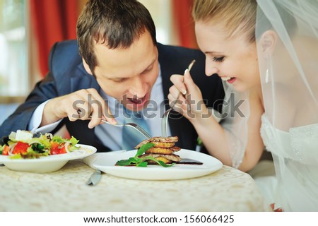 happy groom and bride  together in cafe having fun. Happy newlywed couple at wedding Royalty-Free Stock Photo #156066425
