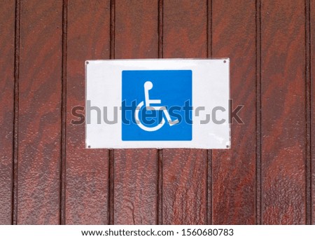 Disabled sign on the side of a wooden building