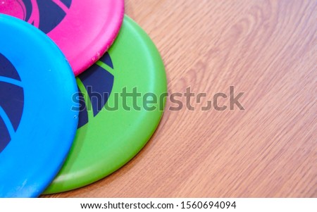Frisbee golf discs on wooden floor