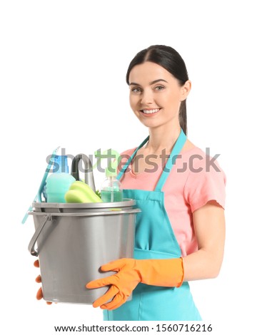 Female janitor with cleaning supplies on white background