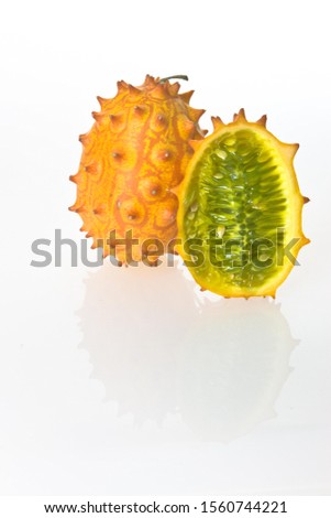 Two Kiwanos, Horned Melons or African Horned Cucumbers (Cucumis metuliferus), one cut in half