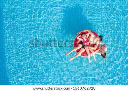 Asian family relax in swimming pool, this image can use for summer, father, moter, summer, water and sport concept