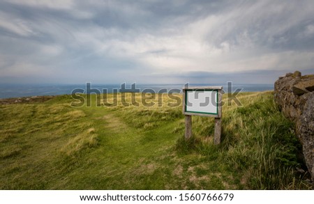 Blank wooden sign, moody landscape, dramatic landscape in Llandudno Wales UK