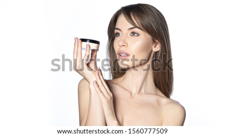 Girl with foundation. Bare shoulders. Makeup concept. Soft focus