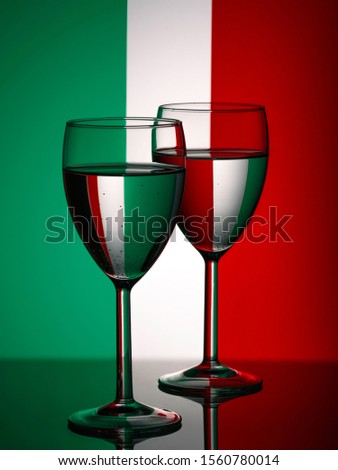 Two wine glasses silhouette full on italian flag background. Alcohol beverage. Italian wine concept. Flag of Italy Royalty-Free Stock Photo #1560780014