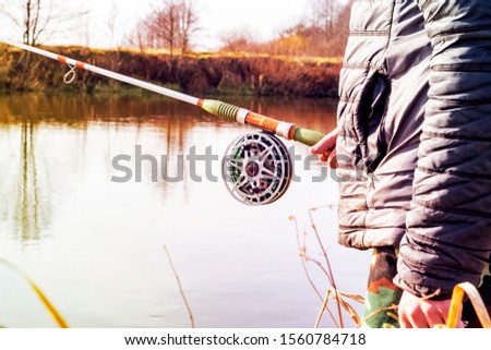 fisherman fishing on a lake spinning at dawn,blur background
