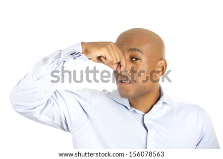Closeup portrait of handsome guy, young executive man, closing nose because something stinks, isolated on white background. Awkward situation and conflict resolution.