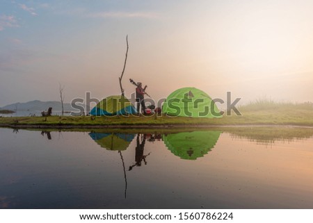 Asian people come to camping and take pictures in the morning. Sun rise Asian river belt