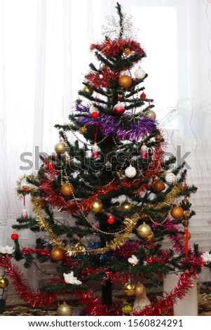 Christmas tree with gifts and decorations at home
