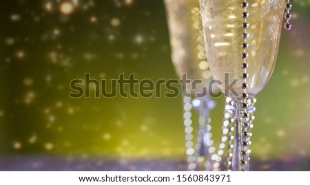 Christmas and New Year holidays background, two glasses and bokeh lights in background